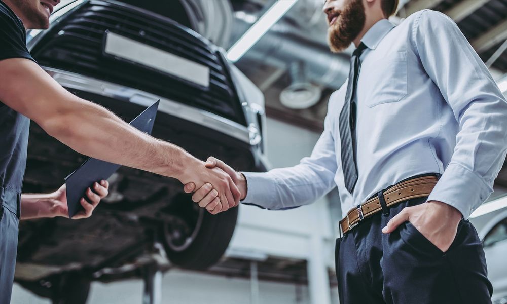 Openbay Men Shaking Hands in Garage